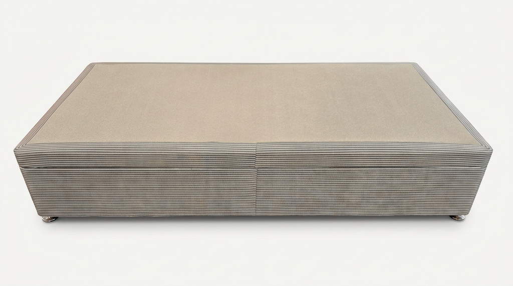 Rectangular single ottoman bed base with a ribbed texture on a white background