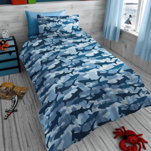 Picture of camouflage patterned bedding with sharks on top of the camouflage.  