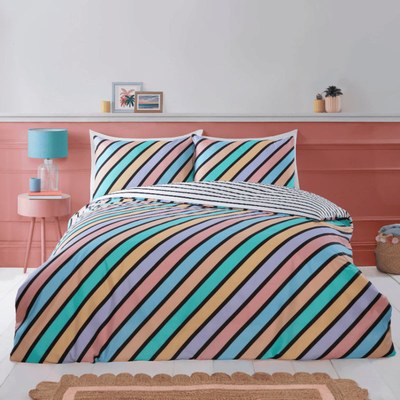 Picture of bedding with blue, green, salmon and light orange stripes on it