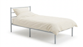 Single metal bed with mattress and cream bedding and pillow on a white background